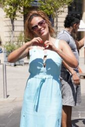 Karol G Embraces Parisian Chic in Sky Blue Sundress