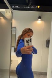 Catherine Paiz Embraces Power Pose in Blue Bodysuit