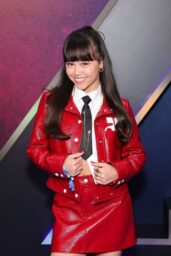 Faith Hedley Attends ‘Zombies 4’ Premiere in Red Leather Prep at El Capitan