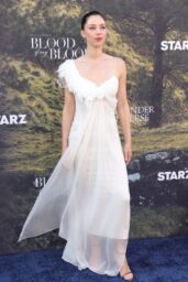 Hermione Corfield Floats in Feathered White at “Outlander” LA Premiere