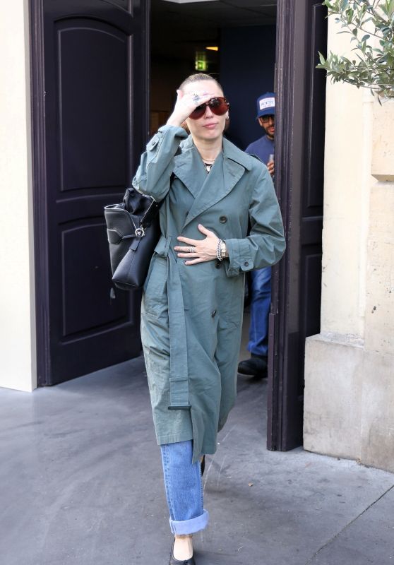 Miley Cyrus Exits Paris Hotel, Debuts Avant-Garde Trench