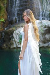 Susanne Regina’s Angelic Turn by a Waterfall – July 2025