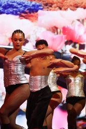 Dua Lipa Ignites the Stage in Sculptural Bronze Bodysuit