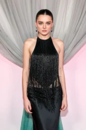 Charlotte Lawrence posing in a black halter fringe gown at Fashion Trust U.S. Awards, Los Angeles April 2026 red carpet