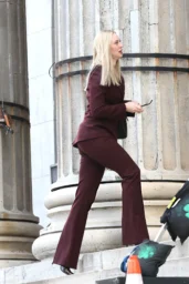 Deborah Ann Woll on the Daredevil Born Again Season 3 set in Downtown Brooklyn wearing a burgundy suit, April 2026