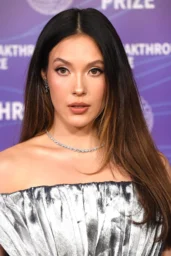 Eileen Gu posing in a metallic silver off-the-shoulder gown at the 12th Breakthrough Prize in Santa Monica, April 2026