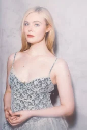 Elle Fanning posing in a Tanner Fletcher silver lace dress and Andrea Wazen Kris Mules for LA Times, April 2026