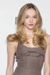 Jayden Bartels posing in a long taupe gown with delicate neckline detailing on the red carpet at The Christophers premiere in New York, April 2026