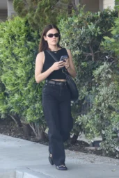 Lucy Hale walking in black cropped top and high-rise jeans at Erewhon, Studio City April 2026 street style