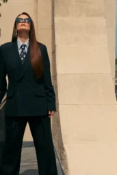 Michelle Dockery posing in an oversized black suit with striped shirt and polka-dot tie for British Airways High Life Magazine photoshoot, September 2025
