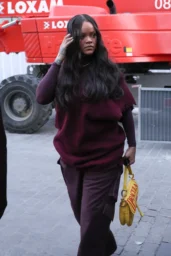 Rihanna and A$AP Rocky walking in Paris in layered burgundy and black street style looks, April 2026