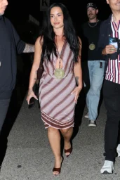 Demi Lovato in a striped halter midi dress at Ariana Grande concert at the Kia Forum