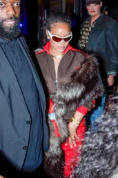 Rihanna in a brown and red Coperni dress with fur coat and red sneakers leaving César restaurant in Paris